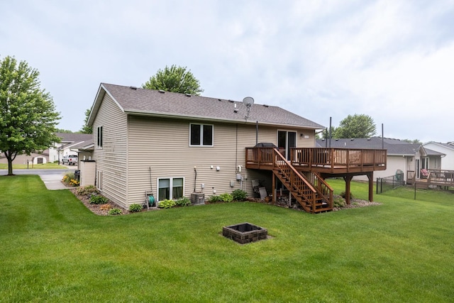 1057 John And Mary Dr SE, Chatfield, MN 55923 - back of house with an outdoor fire pit, a wooden deck, stairs, and roof with shingles