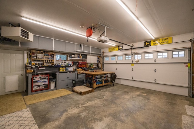 1057 John And Mary Dr SE, Chatfield, MN 55923 - garage featuring a workshop area, a garage door opener, and a heating unit