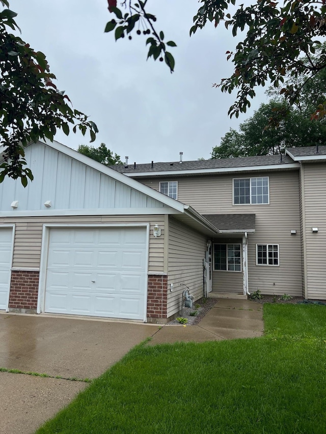444 Terrace View Dr, Litchfield, MN 55355 - view of front of house with brick siding, concrete driveway, a garage, and a front lawn