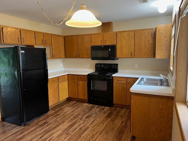 444 Terrace View Dr, Litchfield, MN 55355 - kitchen with black appliances, dark wood-style flooring, brown cabinetry, light countertops, and a textured ceiling