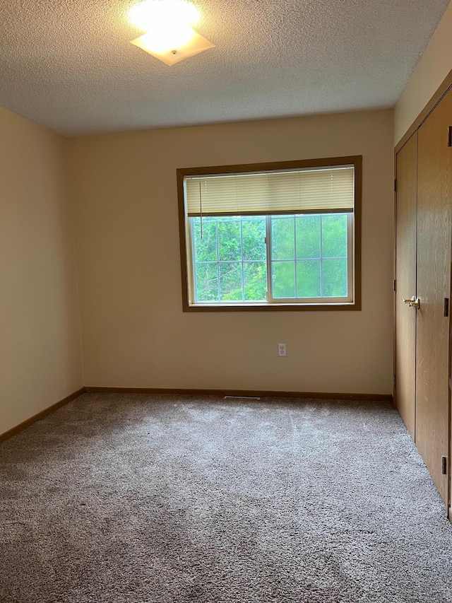 444 Terrace View Dr, Litchfield, MN 55355 - unfurnished bedroom with carpet, a closet, and a textured ceiling