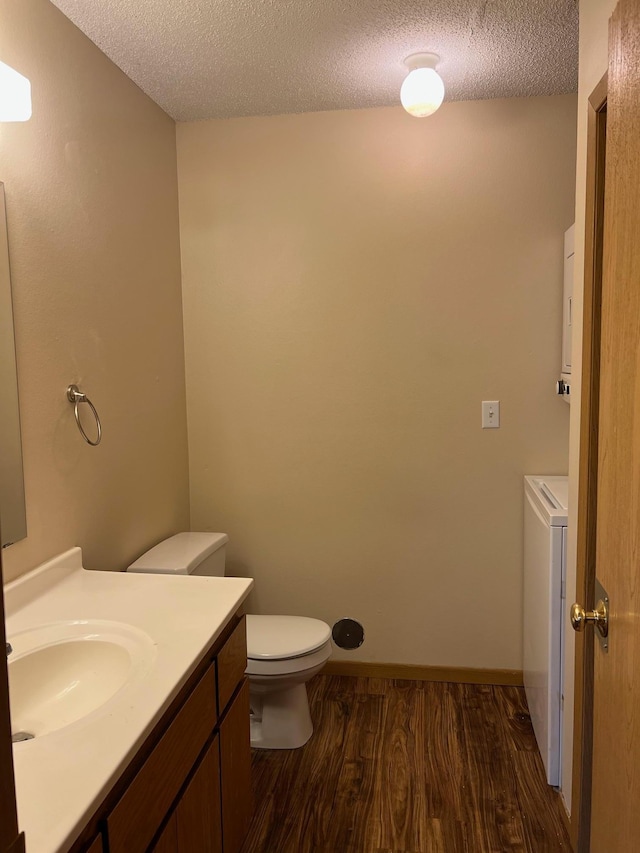 444 Terrace View Dr, Litchfield, MN 55355 - half bath featuring wood finished floors, vanity, a textured ceiling, and washer / clothes dryer
