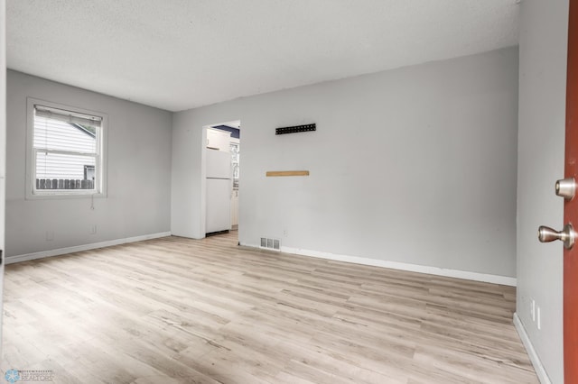 1709 13th Ave S, Fargo, ND 58103 - unfurnished room with light wood-type flooring and a textured ceiling