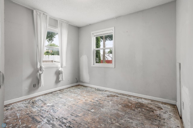 1709 13th Ave S, Fargo, ND 58103 - spare room with plenty of natural light and a textured ceiling