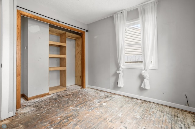 1709 13th Ave S, Fargo, ND 58103 - unfurnished bedroom with baseboards and a textured ceiling