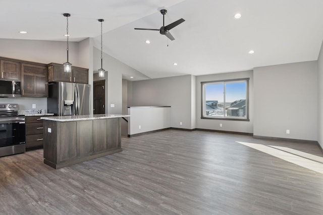 883 Grant St, Ellsworth, WI 54011 - kitchen with stainless steel appliances, dark brown cabinets, ceiling fan, open floor plan, and a kitchen island