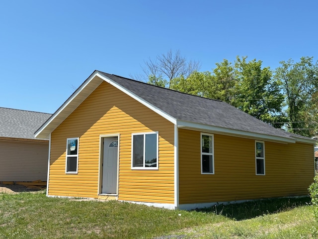 127 1st St NE, Cass Lake, MN 56633 - view of front of house featuring roof with shingles and a front lawn