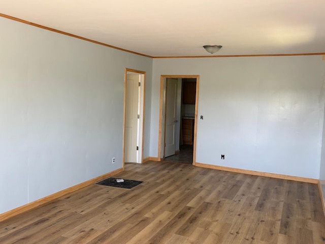 127 1st St NE, Cass Lake, MN 56633 - unfurnished room with wood finished floors and crown molding