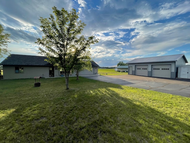 111 W Ave, Ottertail, MN 56571 - view of green lawn with a detached garage and an outbuilding