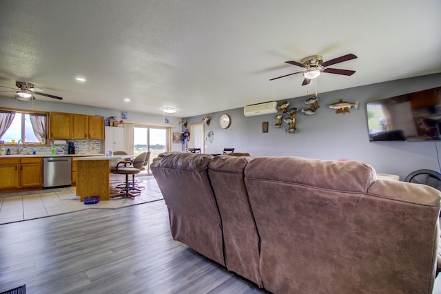 111 W Ave, Ottertail, MN 56571 - living room featuring ceiling fan, healthy amount of natural light, and an AC wall unit