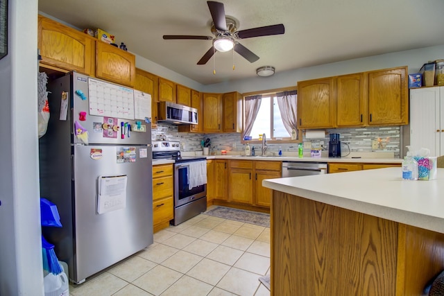 111 W Ave, Ottertail, MN 56571 - kitchen with appliances with stainless steel finishes, light countertops, ceiling fan, and backsplash