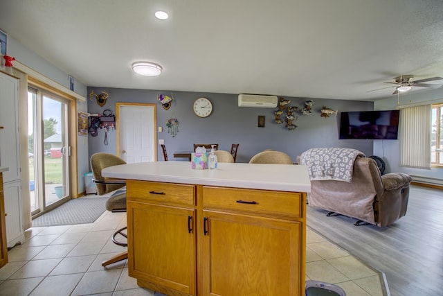 111 W Ave, Ottertail, MN 56571 - kitchen featuring a wall unit AC, ceiling fan, light tile patterned floors, light countertops, and recessed lighting