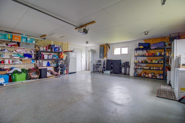 111 W Ave, Ottertail, MN 56571 - garage with freestanding refrigerator, electric panel, and a garage door opener
