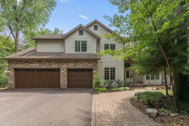 5401 River Oak Dr, Savage, MN 55378 - traditional-style home featuring driveway, brick siding, a shingled roof, and a garage