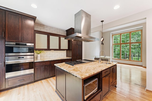 5401 River Oak Dr, Savage, MN 55378 - kitchen featuring island exhaust hood, stainless steel appliances, light wood-type flooring, backsplash, and recessed lighting