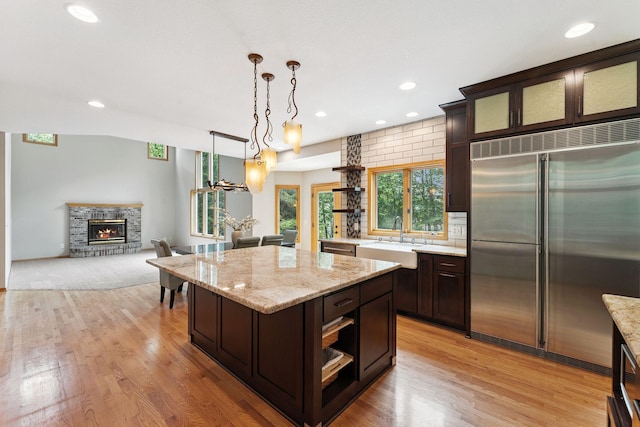 5401 River Oak Dr, Savage, MN 55378 - kitchen with stainless steel built in fridge, open shelves, dark brown cabinetry, and recessed lighting