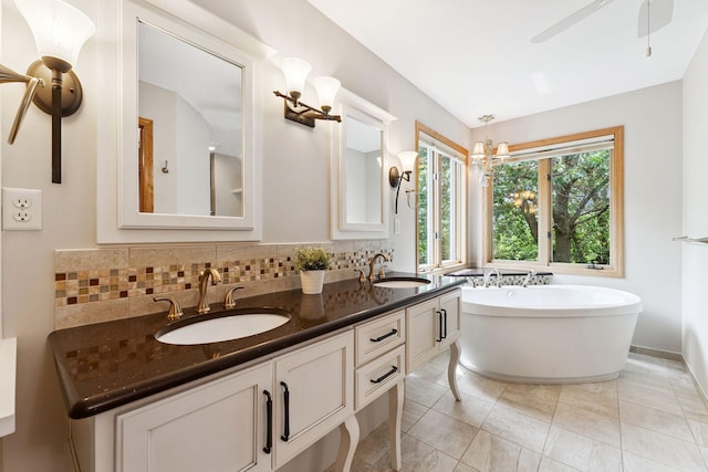 5401 River Oak Dr, Savage, MN 55378 - full bath with a freestanding bath, double vanity, a ceiling fan, and backsplash