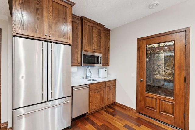 5401 River Oak Dr, Savage, MN 55378 - kitchen with stainless steel appliances, dark wood-style floors, light countertops, and brown cabinets