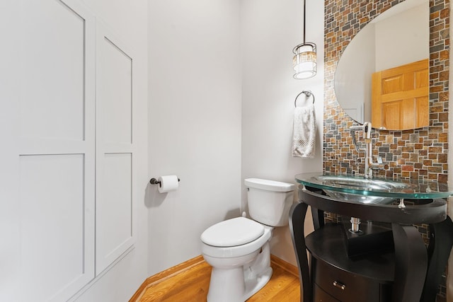 5401 River Oak Dr, Savage, MN 55378 - half bathroom with decorative backsplash and wood finished floors