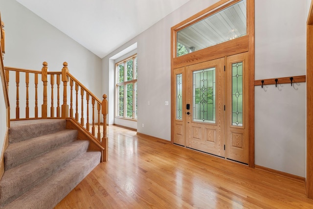 5401 River Oak Dr, Savage, MN 55378 - entrance foyer with light wood-style flooring, vaulted ceiling, and stairway