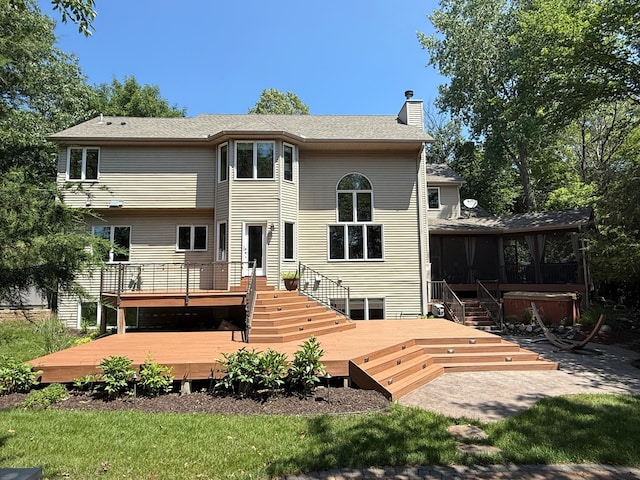 5401 River Oak Dr, Savage, MN 55378 - rear view of property featuring a hot tub, a chimney, a wooden deck, a sunroom, and a patio area