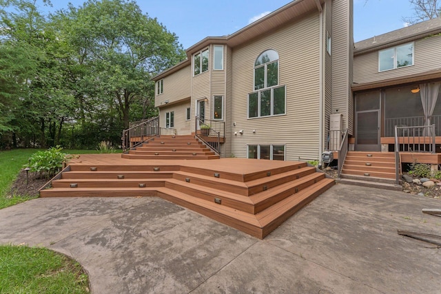 5401 River Oak Dr, Savage, MN 55378 - back of property featuring a patio, a wooden deck, and a sunroom