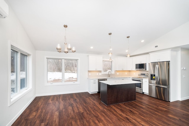 3829 Stebner Rd, Hermantown, MN 55811 - kitchen featuring stainless steel appliances, vaulted ceiling, dark wood finished floors, light countertops, and a kitchen island