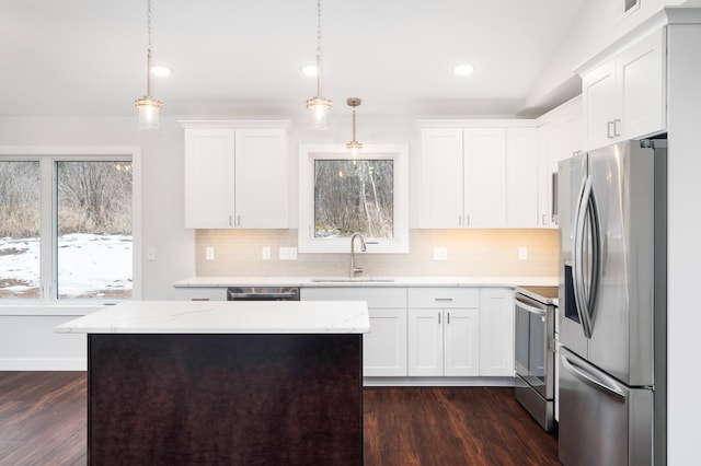 3829 Stebner Rd, Hermantown, MN 55811 - kitchen featuring appliances with stainless steel finishes, tasteful backsplash, dark wood-style floors, white cabinetry, and recessed lighting