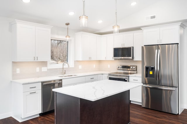 3829 Stebner Rd, Hermantown, MN 55811 - kitchen featuring stainless steel appliances, dark wood-type flooring, white cabinetry, vaulted ceiling, and tasteful backsplash