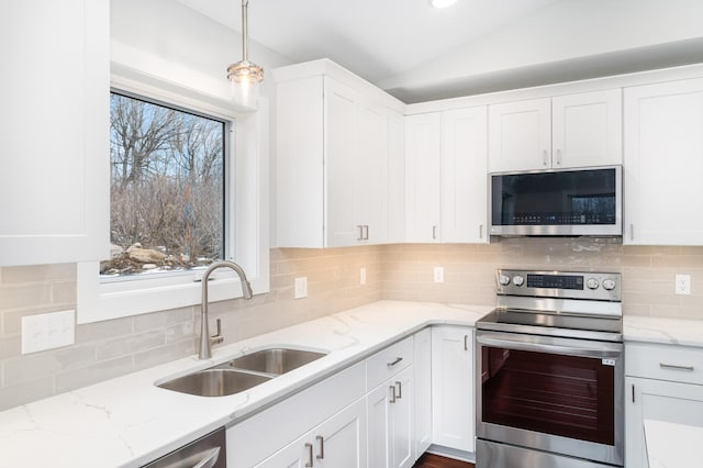 3829 Stebner Rd, Hermantown, MN 55811 - kitchen featuring appliances with stainless steel finishes, lofted ceiling, white cabinetry, and tasteful backsplash