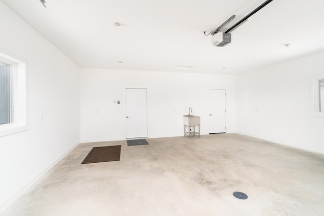 3829 Stebner Rd, Hermantown, MN 55811 - garage featuring a garage door opener and a sink