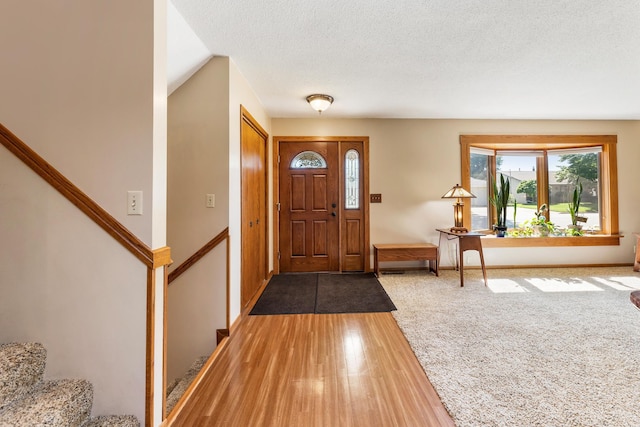 655 48th Ave, Goodview, MN 55987 - foyer with stairs, wood finished floors, and a textured ceiling