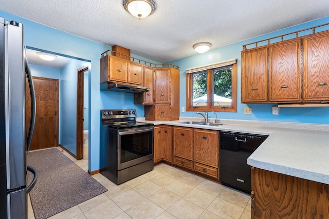 655 48th Ave, Goodview, MN 55987 - kitchen featuring appliances with stainless steel finishes, under cabinet range hood, brown cabinetry, a textured ceiling, and light countertops
