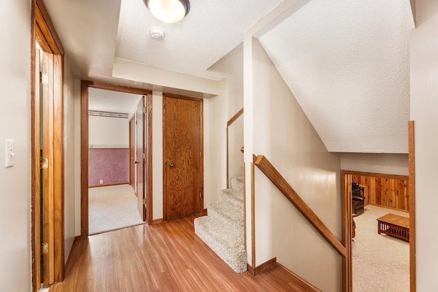 655 48th Ave, Goodview, MN 55987 - hallway featuring light wood-style flooring, a textured ceiling, and stairs