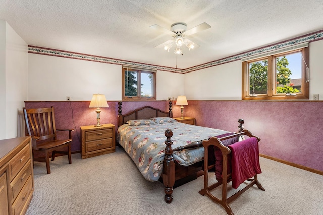 655 48th Ave, Goodview, MN 55987 - bedroom featuring light carpet, a wainscoted wall, a textured ceiling, and a ceiling fan