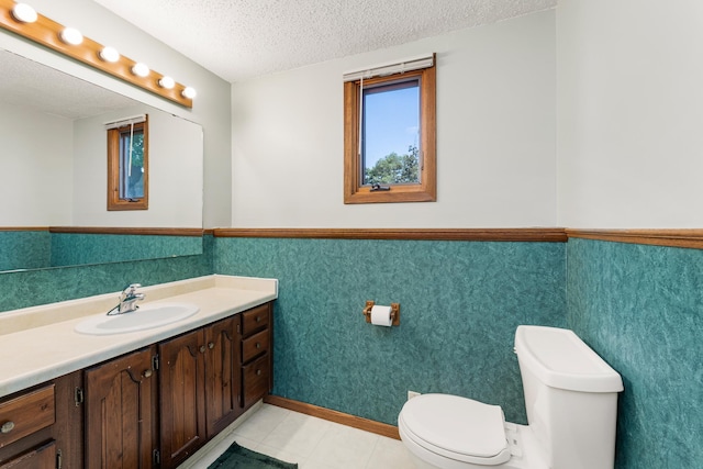 655 48th Ave, Goodview, MN 55987 - bathroom featuring vanity, a textured ceiling, a wainscoted wall, and tile patterned floors