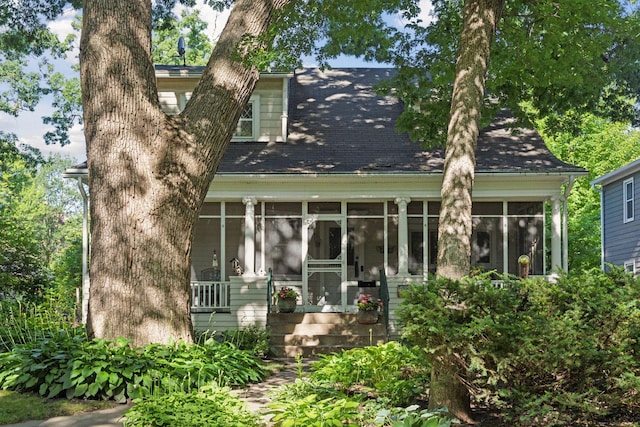 1323 Keston St, Saint Paul, MN 55108 - back of house with a sunroom and a shingled roof