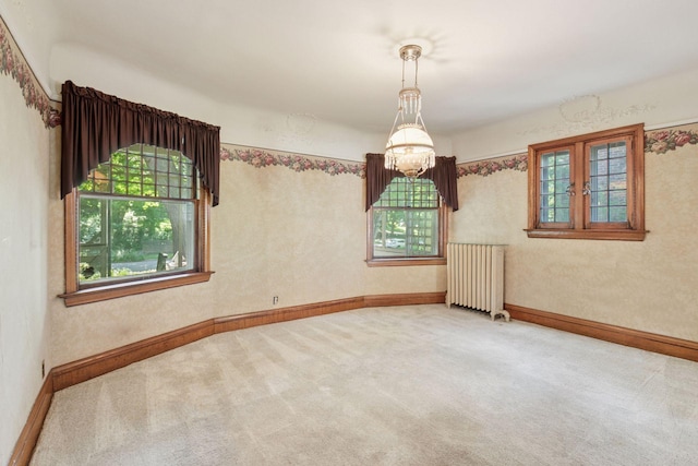 1323 Keston St, Saint Paul, MN 55108 - carpeted spare room with radiator heating unit and healthy amount of natural light