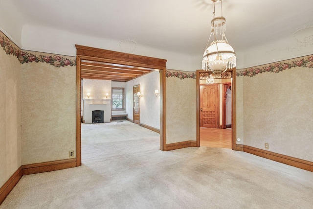 1323 Keston St, Saint Paul, MN 55108 - carpeted spare room featuring a chandelier and a fireplace