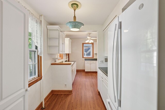 1323 Keston St, Saint Paul, MN 55108 - kitchen featuring freestanding refrigerator, plenty of natural light, and white cabinets
