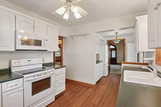 1323 Keston St, Saint Paul, MN 55108 - kitchen featuring white appliances, white cabinets, dark countertops, and wood finished floors