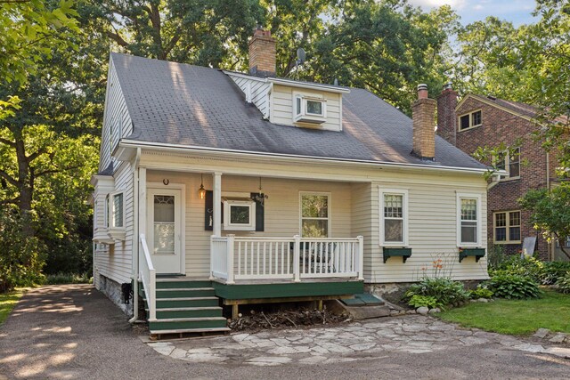 1323 Keston St, Saint Paul, MN 55108 - view of front of house with a chimney and a porch