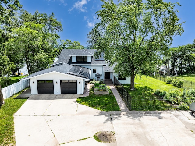 4255 County Road 11 NE, Alexandria, MN 56308 - view of front of property featuring a shingled roof, concrete driveway, solar panels, and a garage