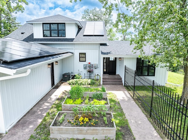 4255 County Road 11 NE, Alexandria, MN 56308 - modern farmhouse featuring a vegetable garden, roof with shingles, and roof mounted solar panels