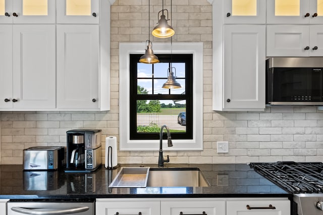 4255 County Road 11 NE, Alexandria, MN 56308 - kitchen with appliances with stainless steel finishes, tasteful backsplash, glass insert cabinets, and white cabinets