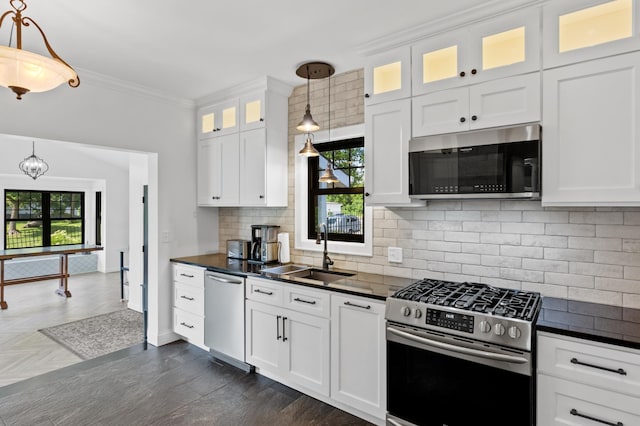 4255 County Road 11 NE, Alexandria, MN 56308 - kitchen featuring stainless steel appliances, dark countertops, plenty of natural light, and crown molding