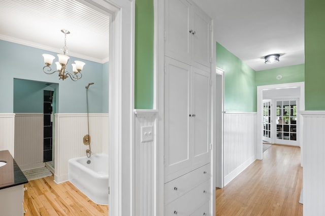 4255 County Road 11 NE, Alexandria, MN 56308 - full bathroom with wainscoting, vanity, wood finished floors, a tub to relax in, and a shower
