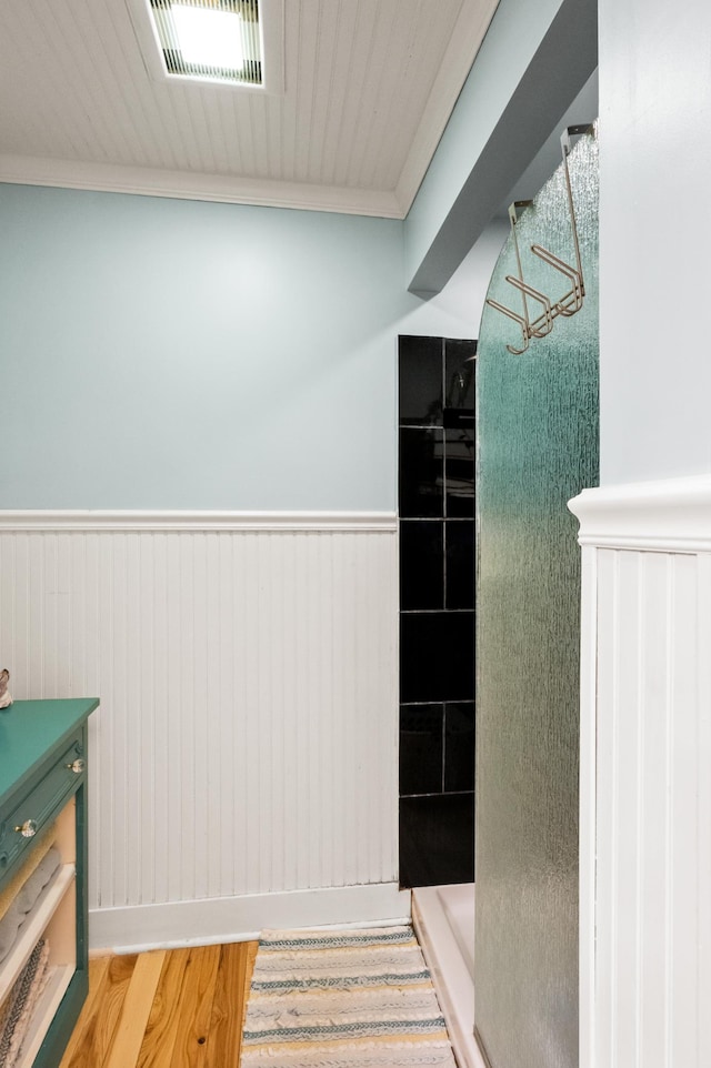 4255 County Road 11 NE, Alexandria, MN 56308 - bathroom featuring a shower stall, a wainscoted wall, wood finished floors, vanity, and ornamental molding