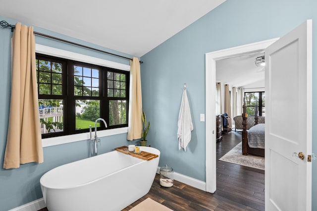4255 County Road 11 NE, Alexandria, MN 56308 - bathroom with a freestanding tub, wood finished floors, and lofted ceiling