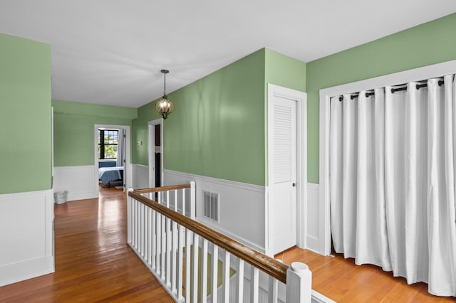 4255 County Road 11 NE, Alexandria, MN 56308 - hallway with an upstairs landing, wainscoting, and wood finished floors